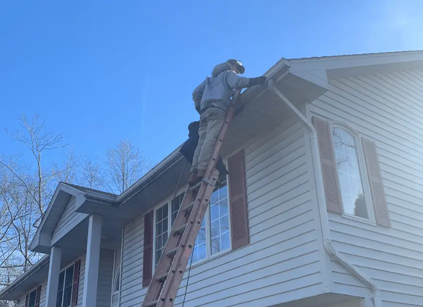 Gutter cleaning and maintenance being performed by Kent Power Washing in Kent